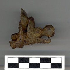 Colour photograph of a rusted dog lock and its flint.