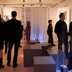 Colour photograph of people visiting an exhibition.