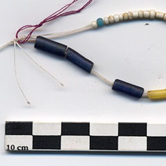 Colour photograph of white glass trade beads and tubular blue and white beads.